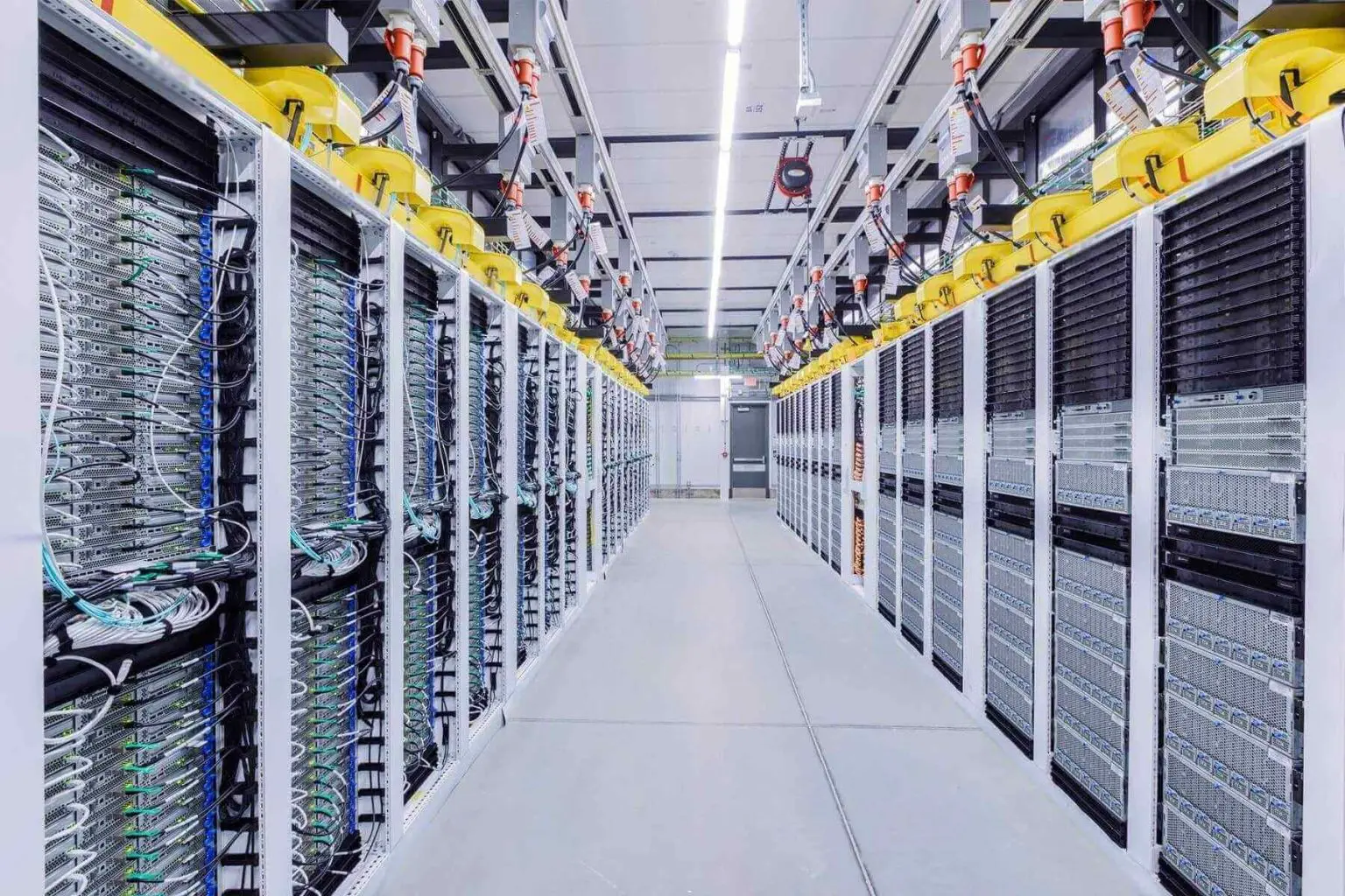 Rows of computing equipment inside a large data centre.